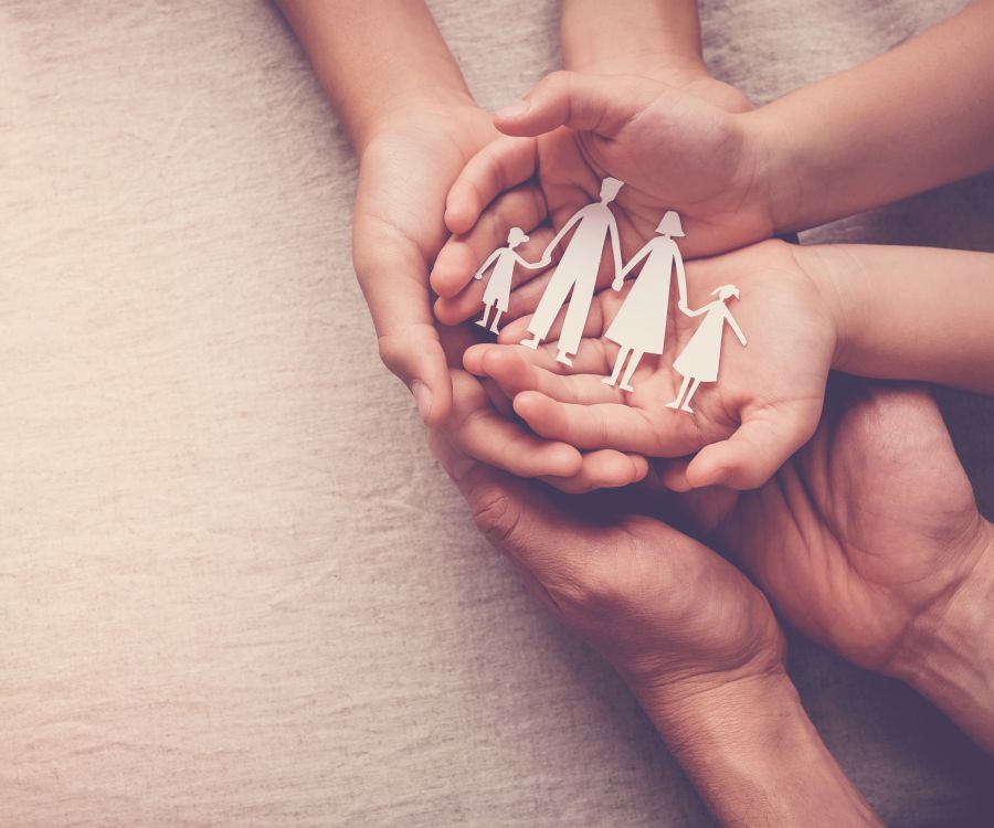 Image of family's palms overlaid with paper cutout of family holding hands