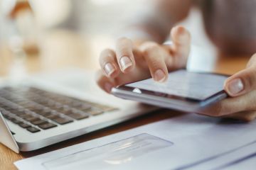person clicking on calculator 
