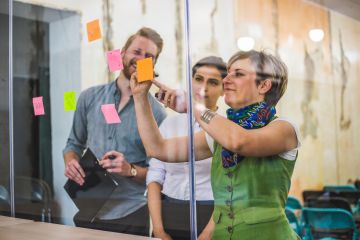 people looking at post it notes